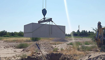 Crane lifting concrete block